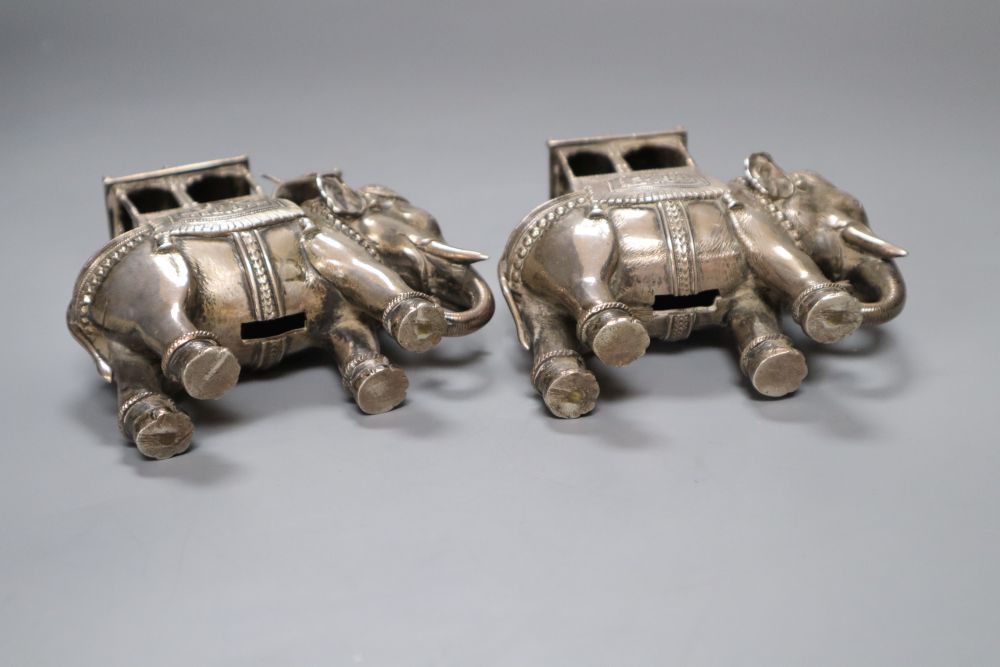 A pair of cast silver plated models of ceremonial elephants, 11cm high